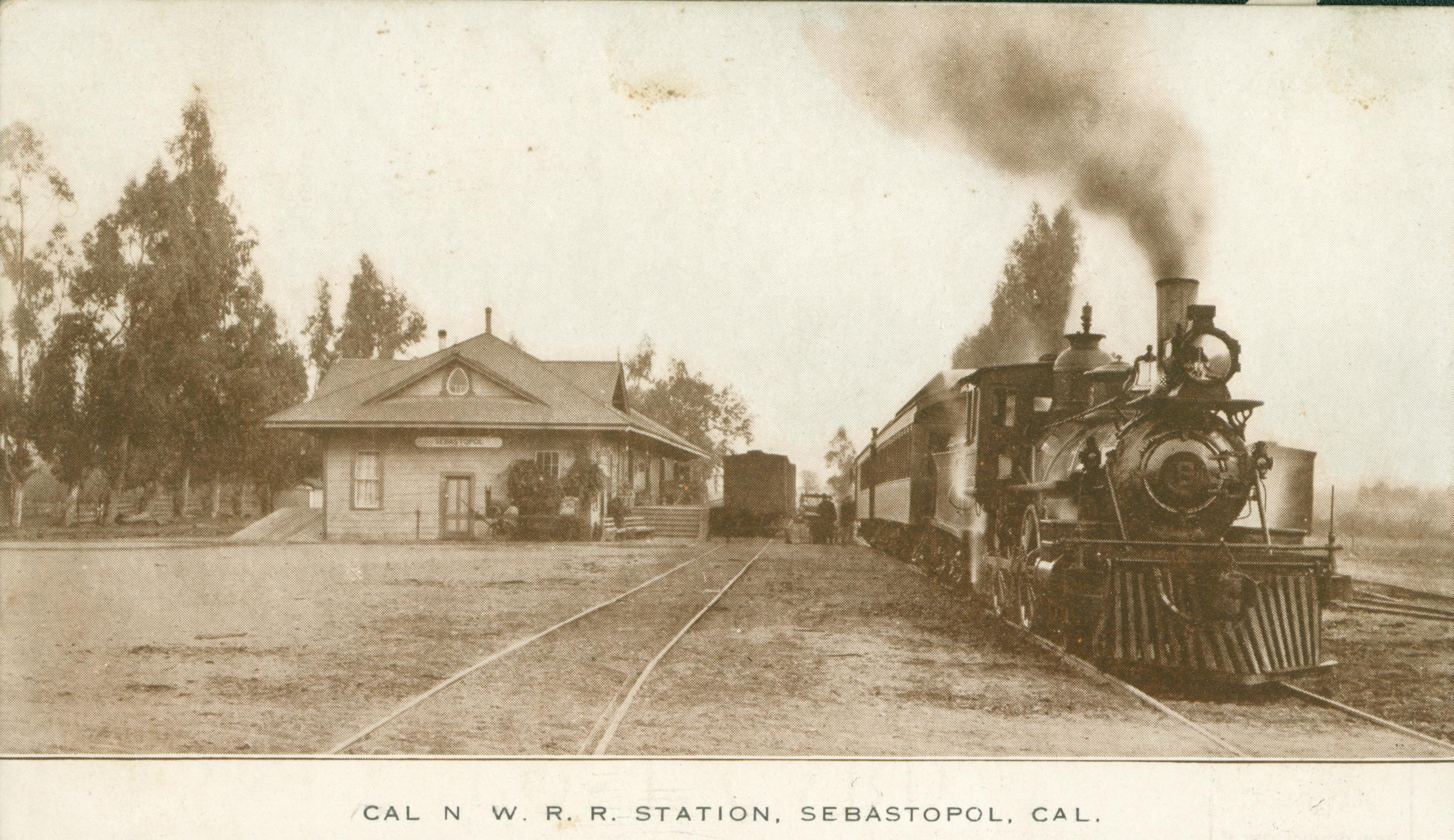 Shows a train pulling out of a railroad depot in Sebastopol